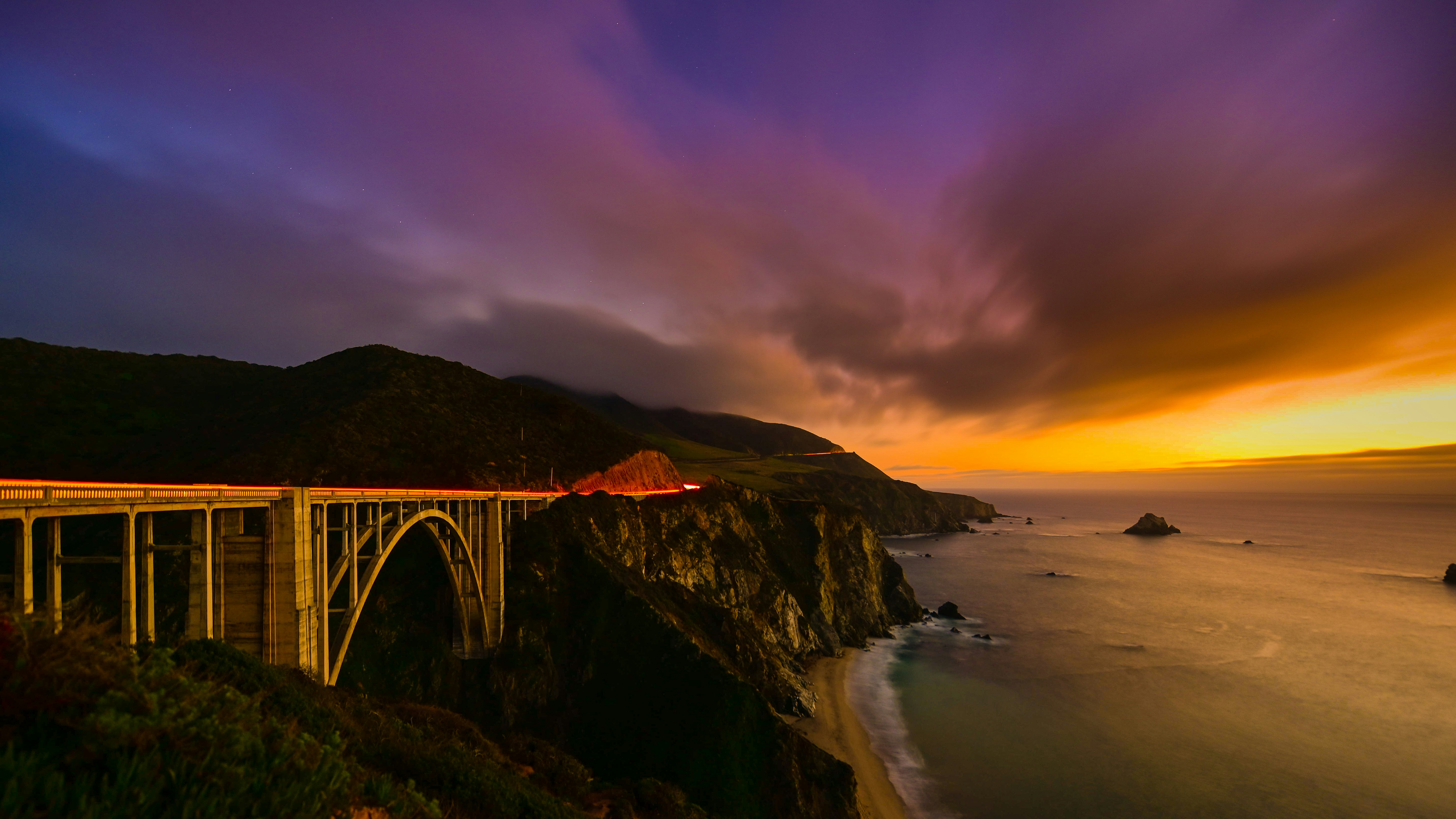 brown suspension bridge beside body of water